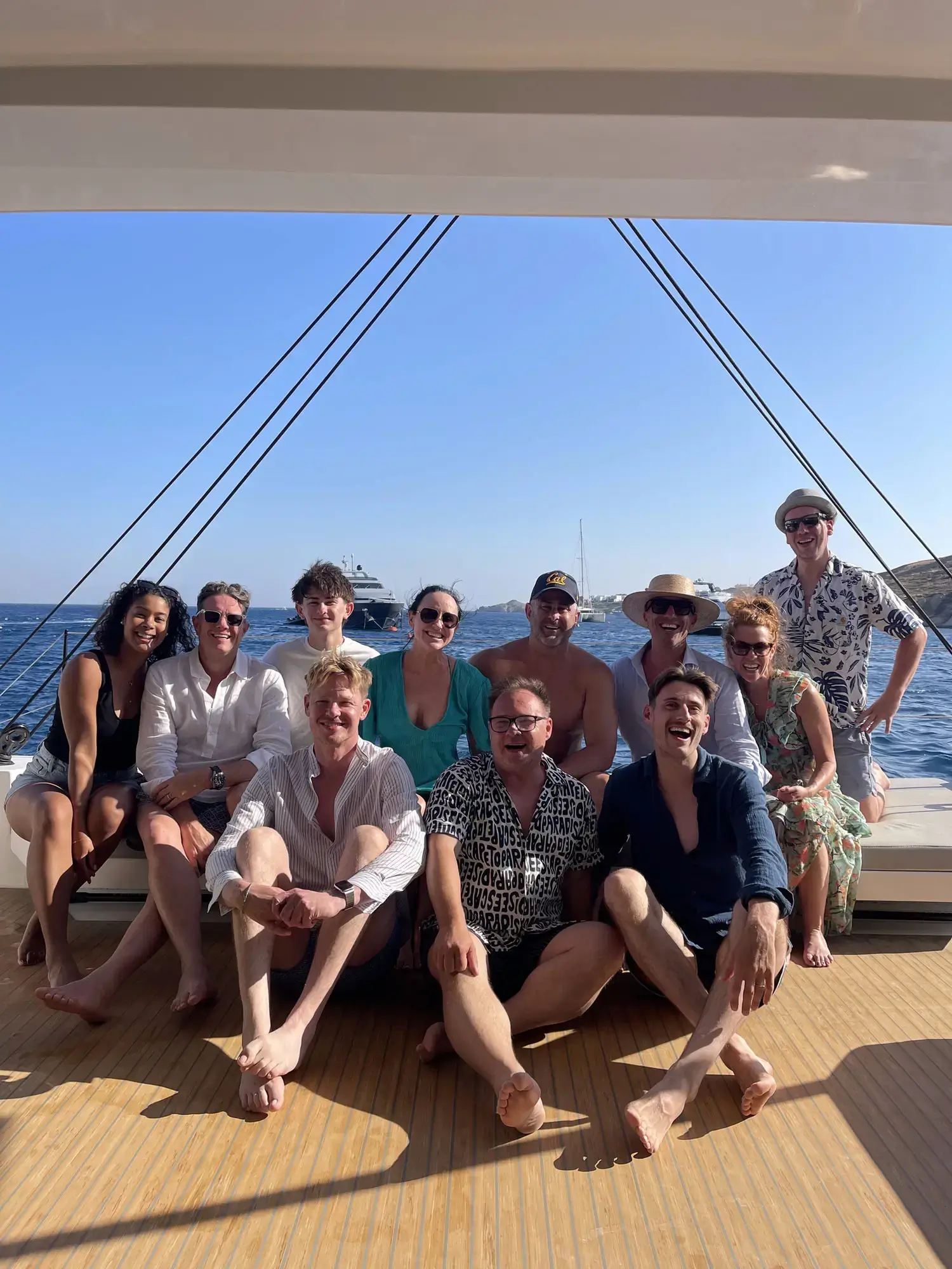Friends and family group photo aboard a private catamaran in the Mykonos waters