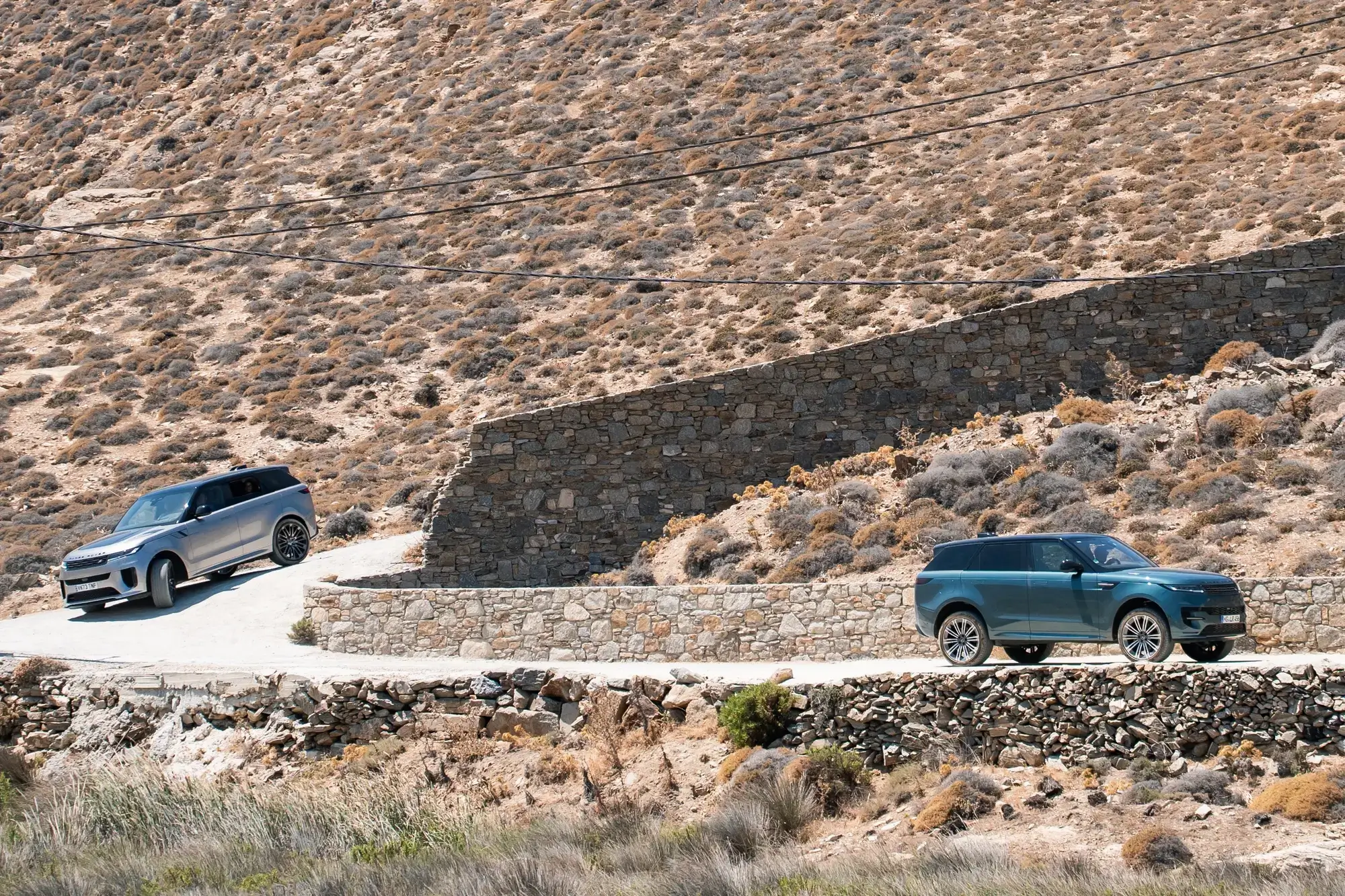 Range Rover SV Sport models navigating the rugged beauty of the Mykonos landscape