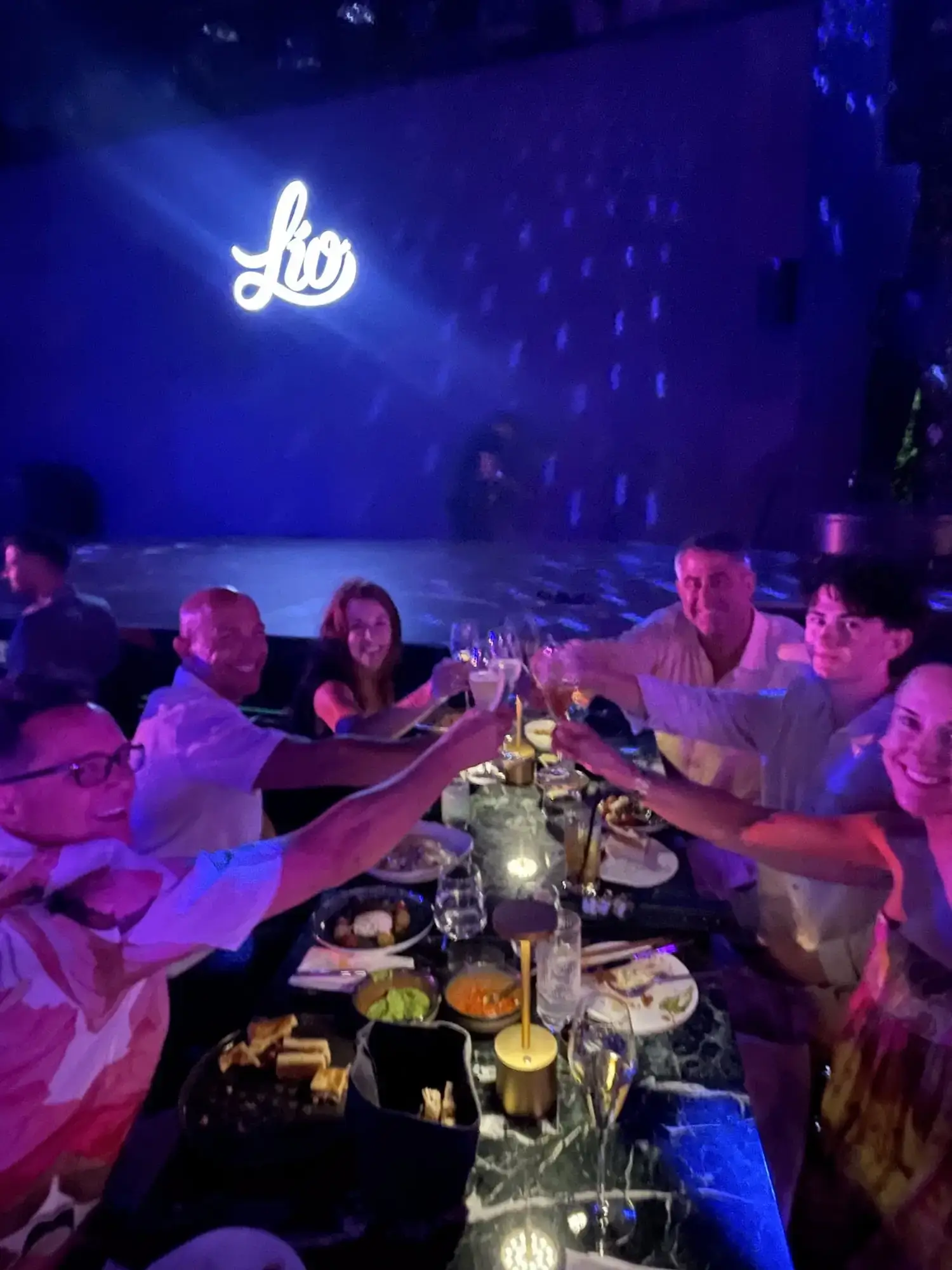 Group toasting at a VIP dinner experience at Lio Mykonos