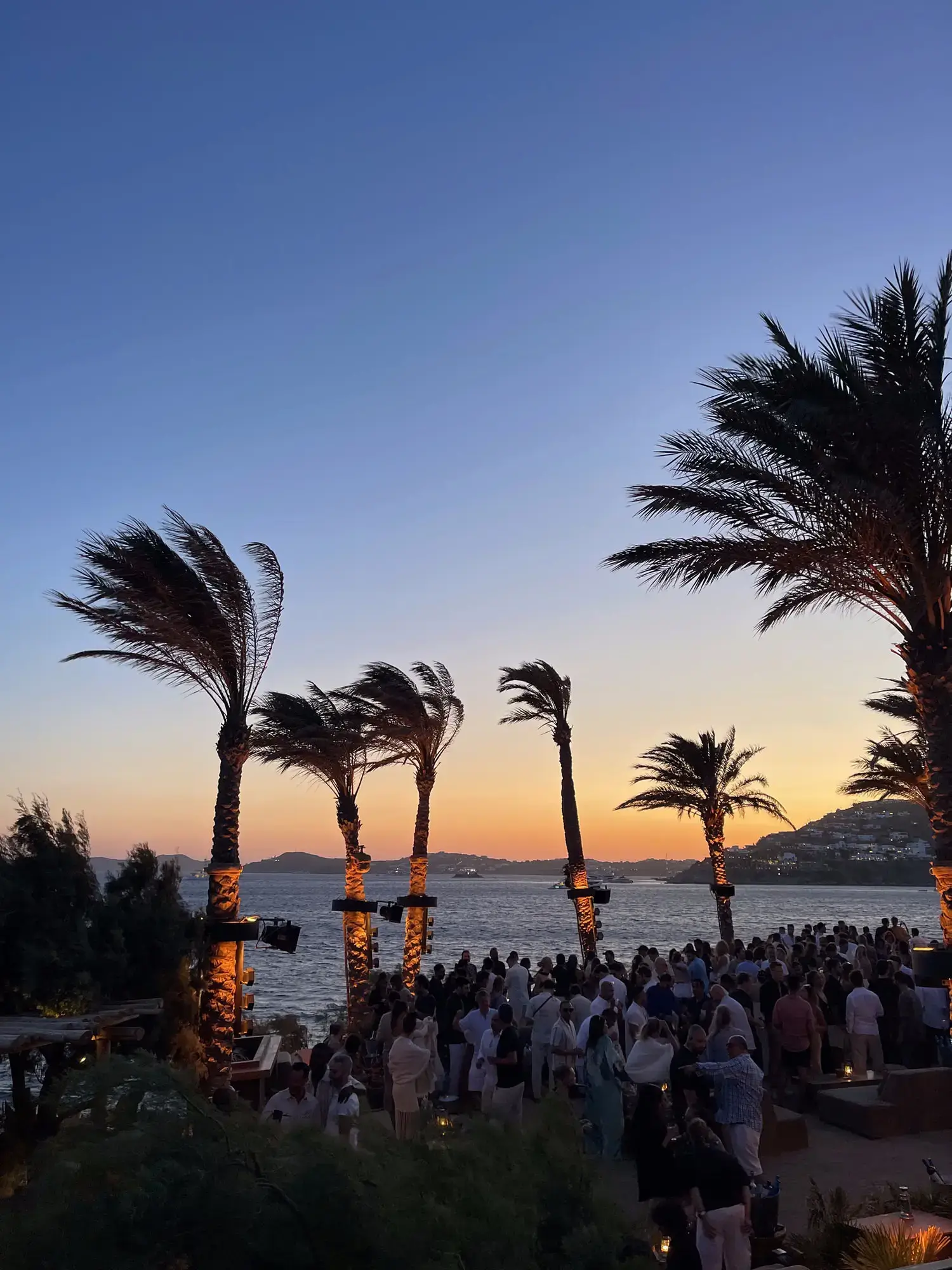 Friends celebrating at a Mykonos nightlife venue during the curated vacation experience