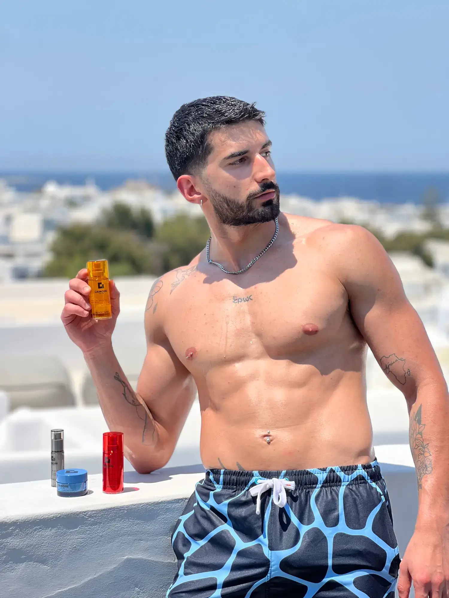 Content creator showcasing Grimoire NYC products on a Mykonos rooftop with sea views
